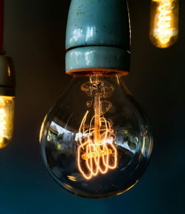 turned on clear glass light bulb