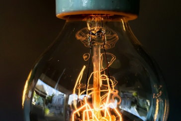 turned on clear glass light bulb