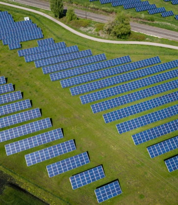 aerial photography of grass field with blue solar panels
